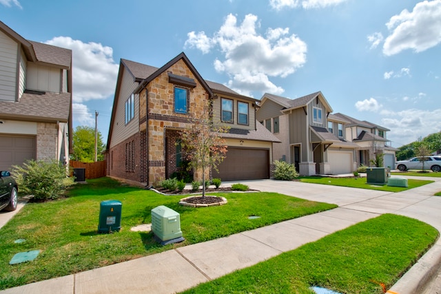 multi unit property with a garage and a front yard