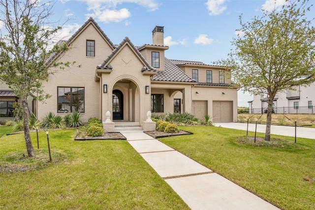 view of front facade with a garage and a front lawn