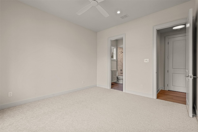 unfurnished bedroom featuring ceiling fan, carpet flooring, and ensuite bath