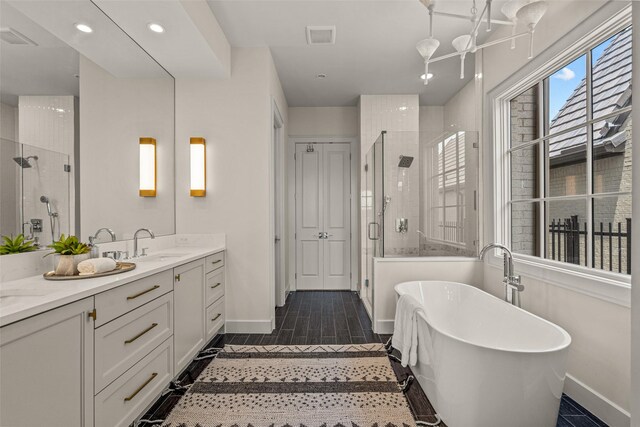 bathroom featuring vanity, tile patterned flooring, and shower with separate bathtub