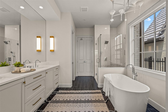 bathroom featuring independent shower and bath and vanity