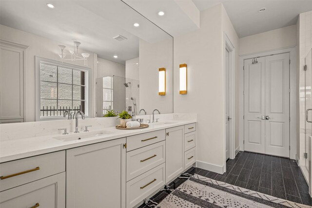 bathroom featuring double vanity and walk in shower