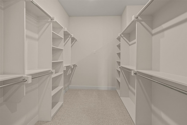 walk in closet featuring light carpet