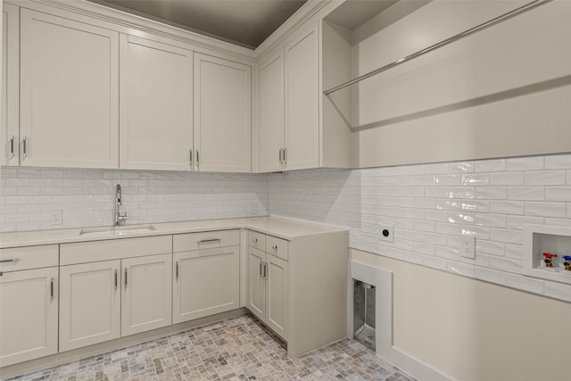 laundry area with sink, cabinets, hookup for a washing machine, and light tile patterned floors