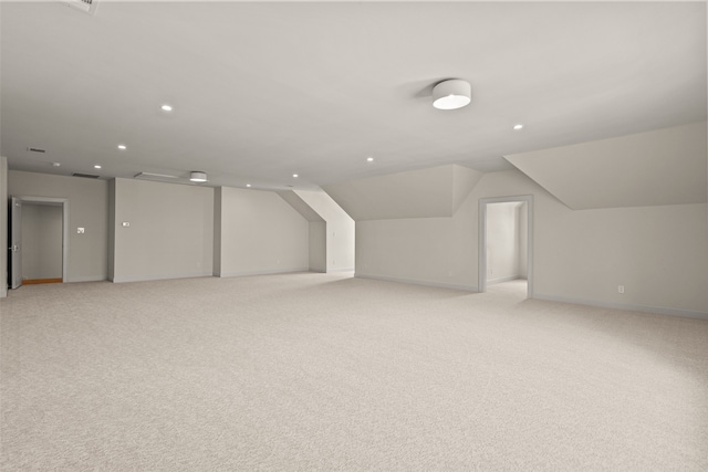 additional living space featuring light carpet and lofted ceiling