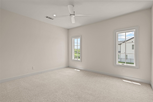 carpeted spare room with ceiling fan