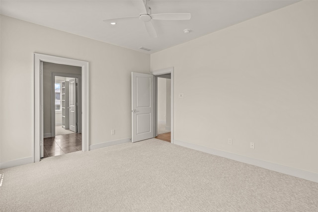 unfurnished bedroom featuring ceiling fan and carpet flooring