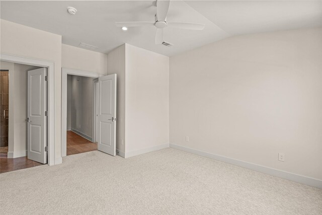 unfurnished bedroom with carpet, ceiling fan, and vaulted ceiling