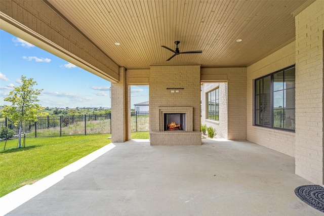 view of patio / terrace with ceiling fan and an outdoor brick fireplace