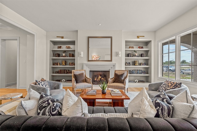 living room with built in features and hardwood / wood-style flooring