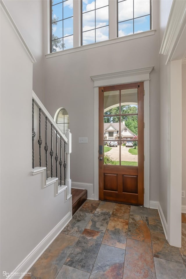 entryway featuring a towering ceiling