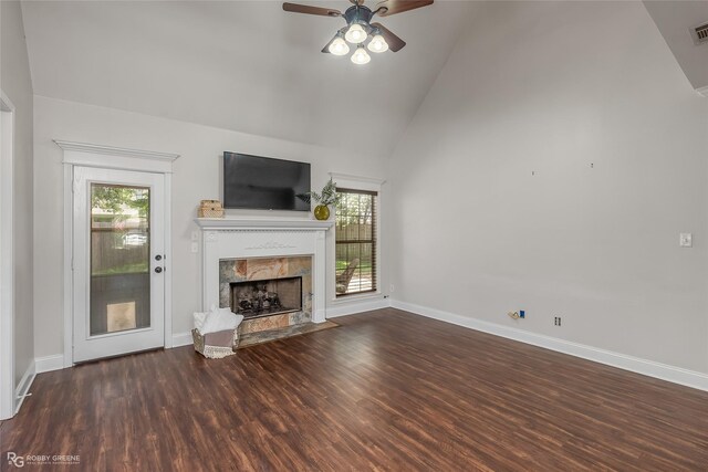 unfurnished living room with a fireplace, a healthy amount of sunlight, hardwood / wood-style floors, and ceiling fan