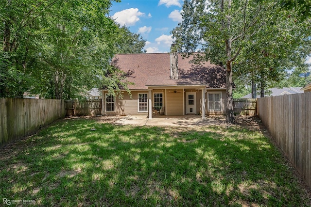 back of house featuring a yard and a patio area