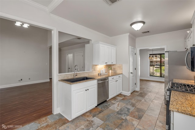 kitchen featuring appliances with stainless steel finishes, sink, decorative backsplash, and white cabinets