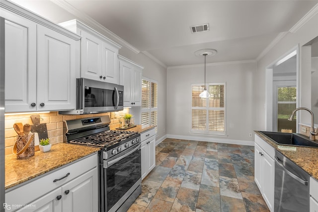 kitchen with tasteful backsplash, sink, white cabinets, light stone counters, and stainless steel appliances