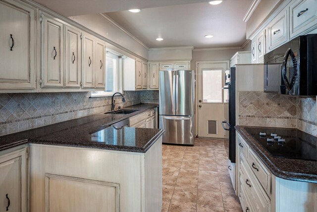 kitchen with decorative backsplash, ceiling fan, sink, and stainless steel fridge