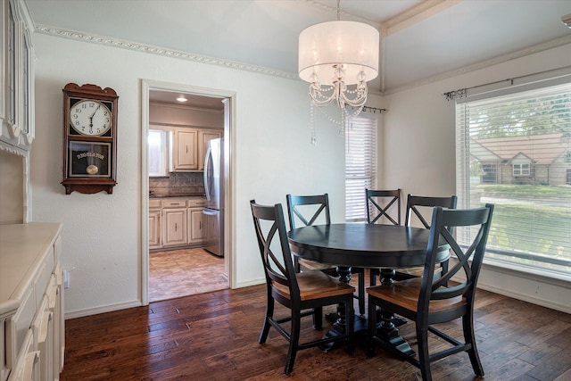 dining space with an inviting chandelier, dark hardwood / wood-style floors, and crown molding