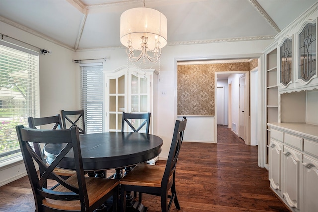 dining space with dark hardwood / wood-style flooring, a notable chandelier, a healthy amount of sunlight, and vaulted ceiling