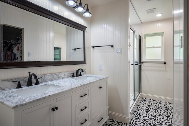 bathroom with vanity and a shower with shower door