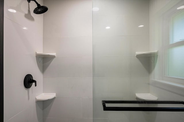 bathroom featuring a shower with shower door, vanity, and tile patterned floors