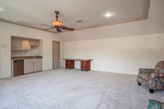 carpeted living room with lofted ceiling, ceiling fan, sink, and crown molding