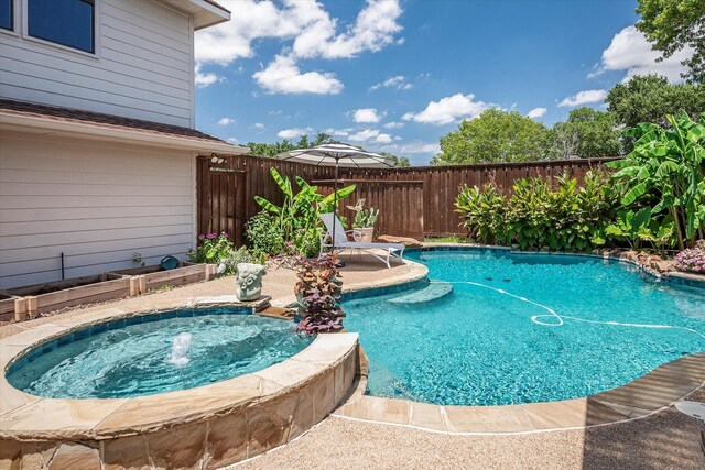 view of pool featuring a patio and an in ground hot tub