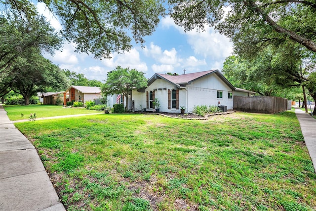 ranch-style house featuring cooling unit and a front lawn