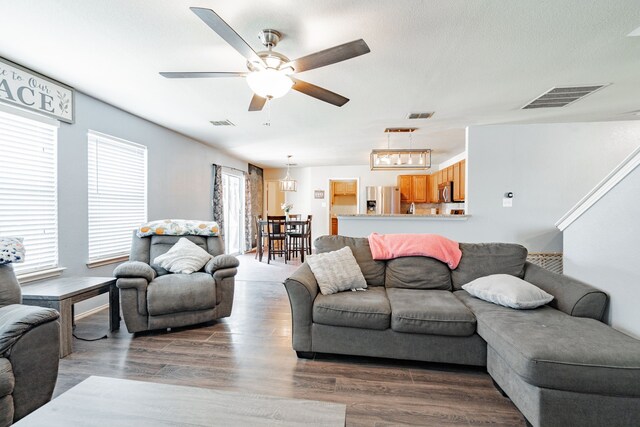 living room with ceiling fan and wood-type flooring