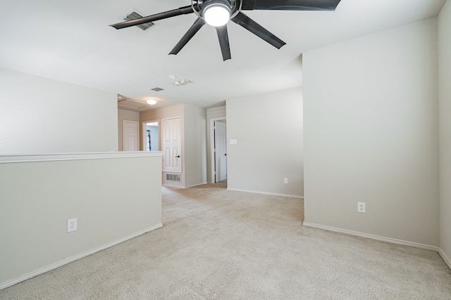 spare room featuring light colored carpet and ceiling fan