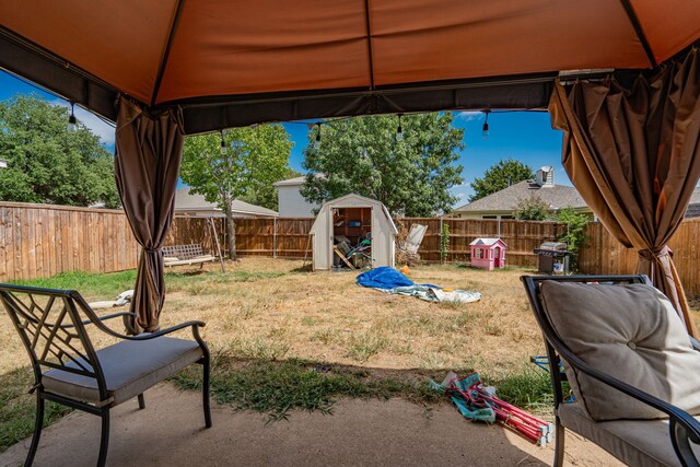 view of yard with a gazebo and a storage unit