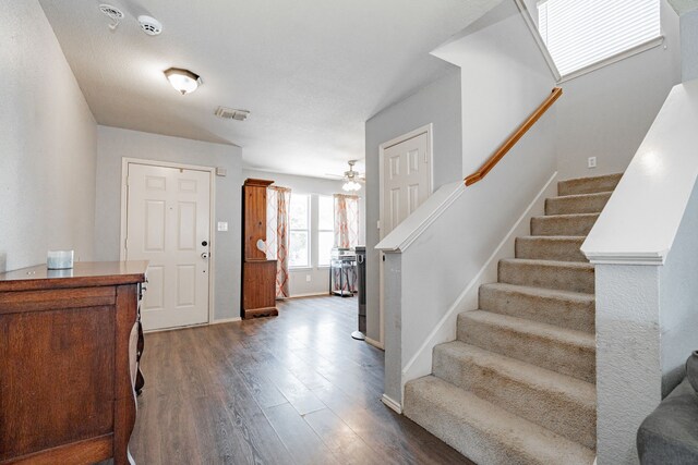 foyer featuring wood-type flooring and ceiling fan