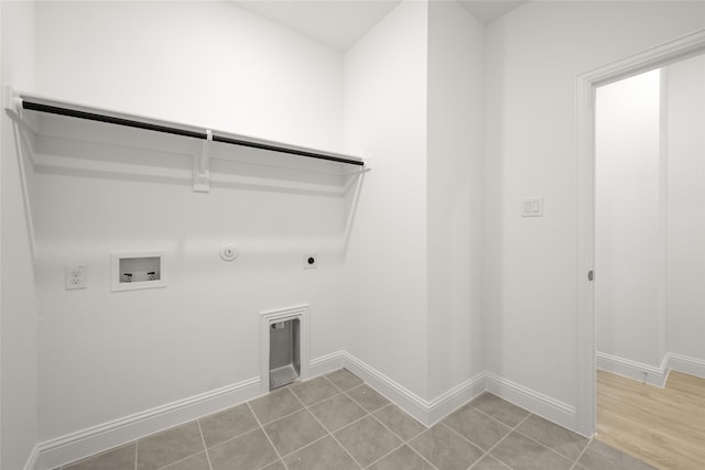 laundry area featuring hookup for a washing machine, electric dryer hookup, gas dryer hookup, and light tile patterned flooring