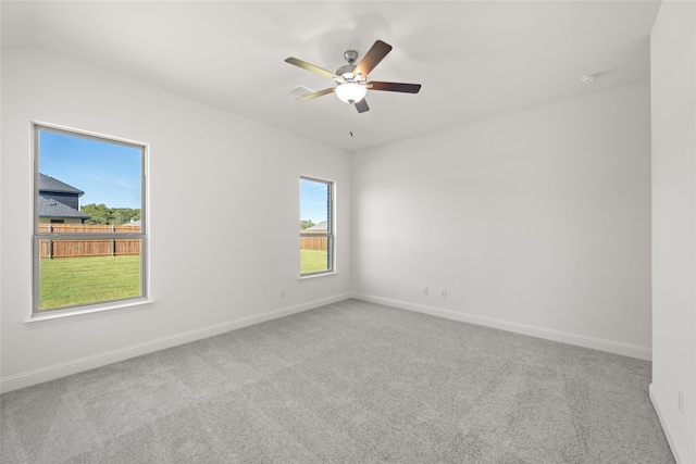 unfurnished room featuring ceiling fan, vaulted ceiling, and carpet floors