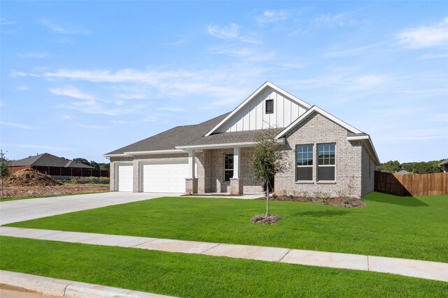 view of front of house with a garage and a front lawn