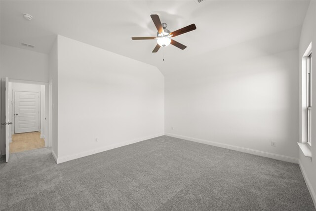 carpeted spare room with ceiling fan and lofted ceiling