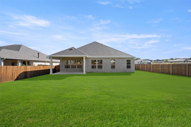 back of property featuring a yard and a patio