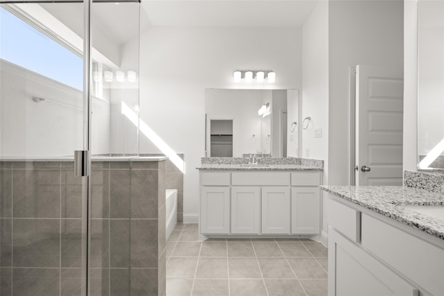 bathroom with vanity, separate shower and tub, tile patterned floors, and lofted ceiling