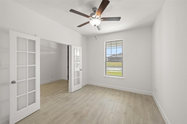 spare room featuring french doors, light wood-type flooring, and ceiling fan