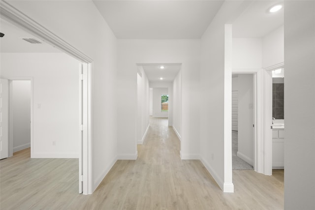 corridor with light wood-type flooring