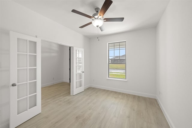 unfurnished room featuring ceiling fan, light wood-type flooring, and french doors