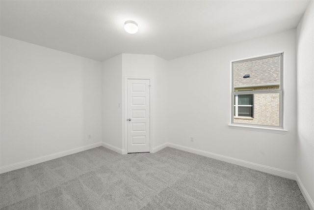 unfurnished room with light colored carpet