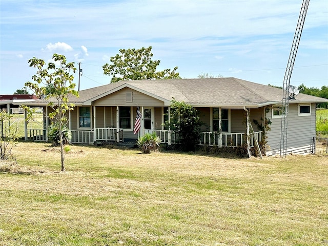 ranch-style house featuring a front lawn and covered porch