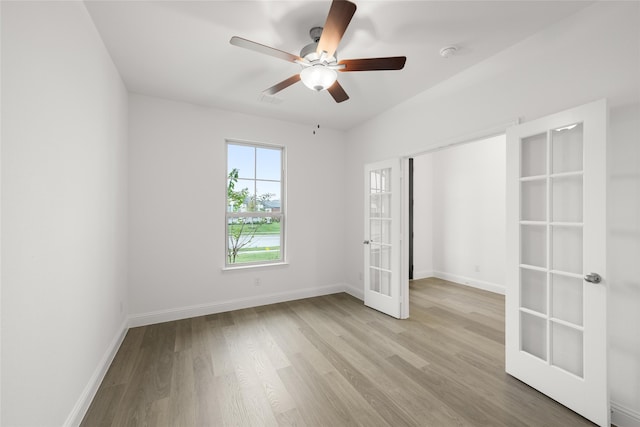 unfurnished bedroom with ceiling fan, light wood-type flooring, and french doors