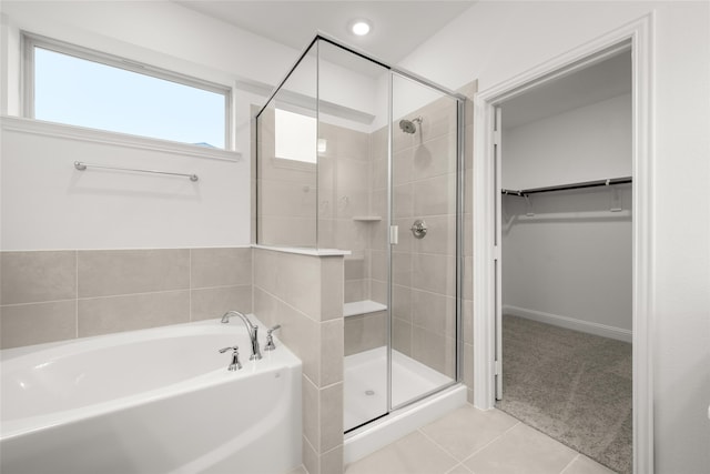 bathroom featuring tile patterned flooring and independent shower and bath