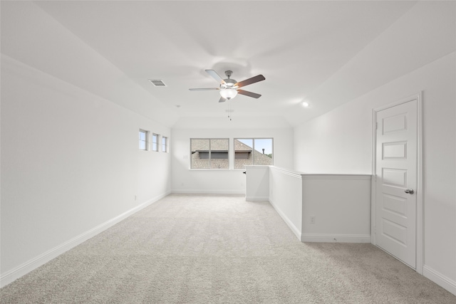 empty room featuring ceiling fan and light colored carpet