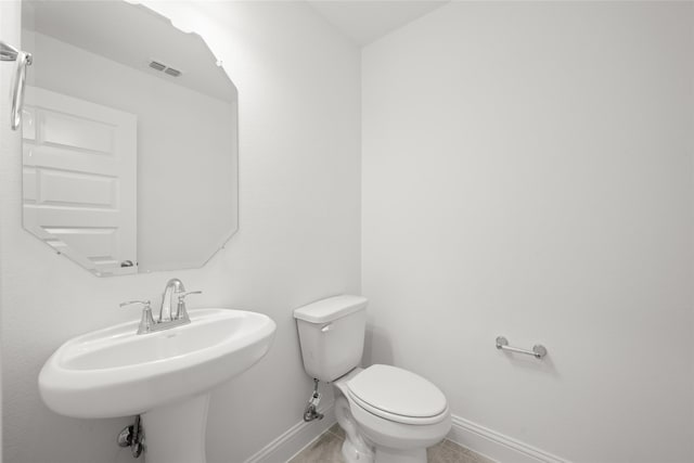 bathroom with tile patterned floors, toilet, and sink