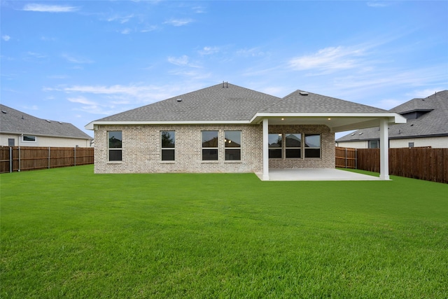 back of property featuring a yard and a patio