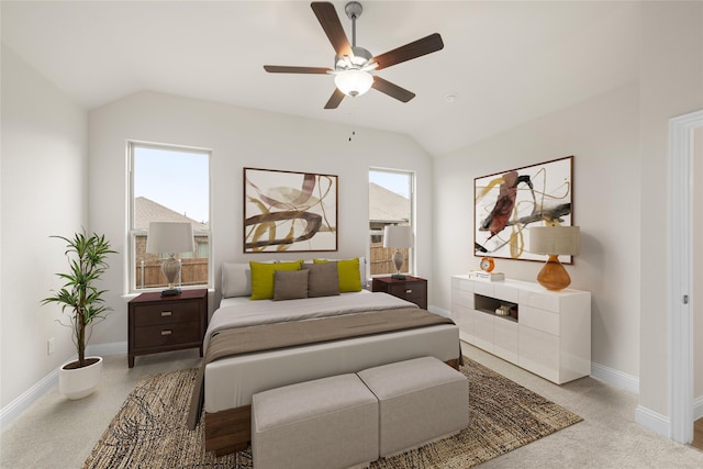 carpeted bedroom featuring ceiling fan, multiple windows, and vaulted ceiling