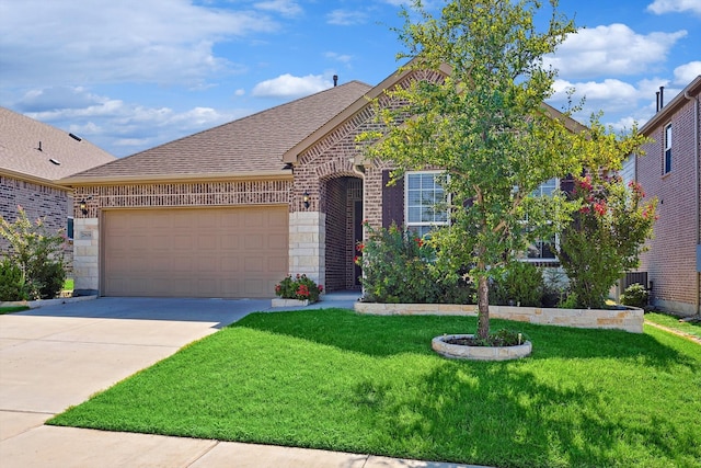 view of front of home featuring a garage and a front lawn