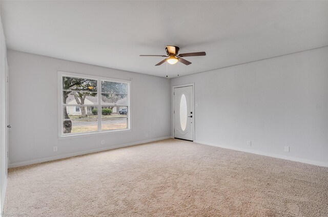 empty room featuring a wall mounted air conditioner and ceiling fan